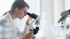 Clinician looking through a microscope