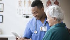 Health care team member reviewing medical history with patient