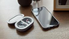 Bose SoundControl Hearing Aids in their case on a table next to an iPhone