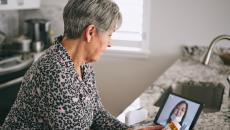 Patient interacting with healthcare professional via tablet