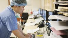 healthcare worker checks an electronic medical record