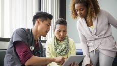 Healthcare worker consulting with a patient and family member