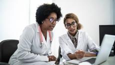 two women reviewing data on a computer