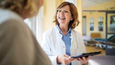 Doctor in discussion with woman at nursing home