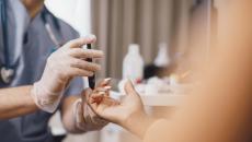 Doctor taking a patient's blood sample in a clinic