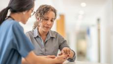 Doctor shows patient phone 