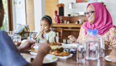 multigenerational family eating a meal at a table