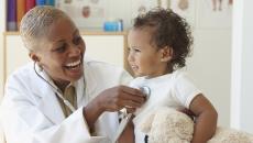 Healthcare provider checking a small patient