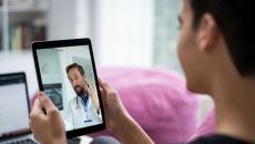 Person talking to a healthcare provider on a tablet