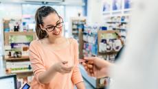 Consumer getting their debit card back at the pharmacy