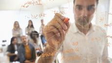 Man demonstrating math formula.