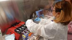 Researcher at the Kennedy Space Center preparing the programmable syringe pumps 