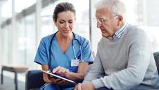 Older patient speaking with healthcare professional