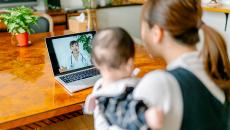 A mother and child during a telehealth video visit