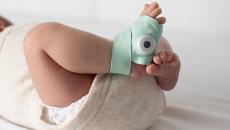 A product shot of the Owlet Smart Sock V3 on an infant