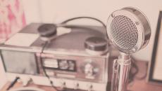 An old-time radio with microphone on a desk represents the podcast