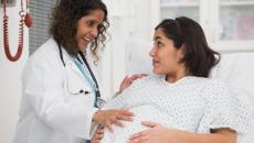 Doctor examining pregnant person