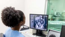 Radiologist looking at CAT scan monitor