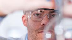 Clinician examining the contents of a test tube