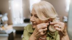 Person adjusting their hearing aid