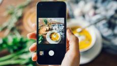 Person taking a photo of their meal with a smartphone