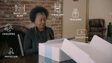 Woman unboxing Virta Health kit