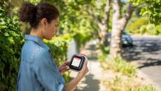 A woman holding the Avive device that is displaying a map