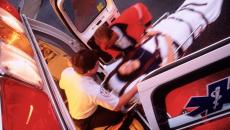 Paramedics loading a patient onto an ambulance