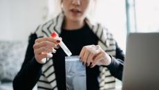 Person putting test tube in a bag