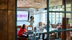 A woman presents in front of colleagues or investors