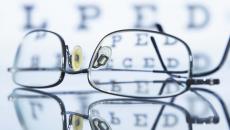 Glasses lying in front of an eye chart