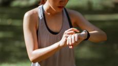 A runner checking their vital signs on their fitness tracker