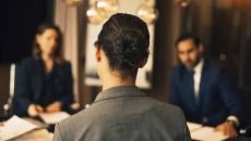 rear view of a person sitting at a table in a business meeting