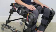 A person wearing the prototype hybrid wheelchair and exoskeleton