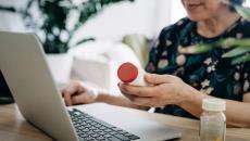 senior using computer to manage her health condition.