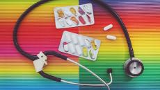 Stethoscope and pills on a colorful background