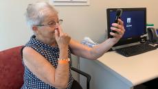 A patient uses a smartphone screening test to analyze stroke-like symptoms she's experiencing.