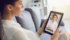 A person talks with a provider using a tablet