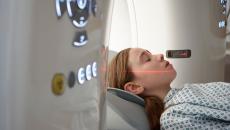 Person lying down preparing to roll into a diagnostic imaging machine