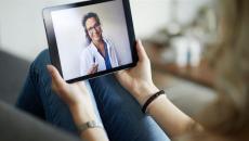 Person speaking to healthcare provider on a tablet