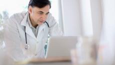 A doctor using a laptop computer