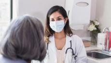 A doctor consulting with an elderly patient