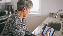 Patient interacting with healthcare professional via tablet