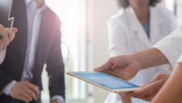 Employees reviewing data on a tablet