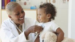 Healthcare provider checking a small patient