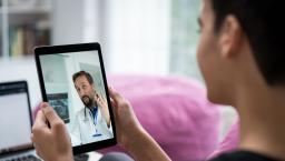 Person talking to a healthcare provider on a tablet