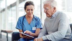 Older patient speaking with healthcare professional