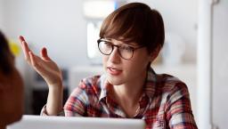 Person on a computer talking and wearing glasses