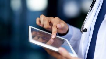 Healthcare provider holding a tablet