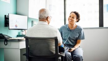 Healthcare provider talking in a patient in a clinical setting